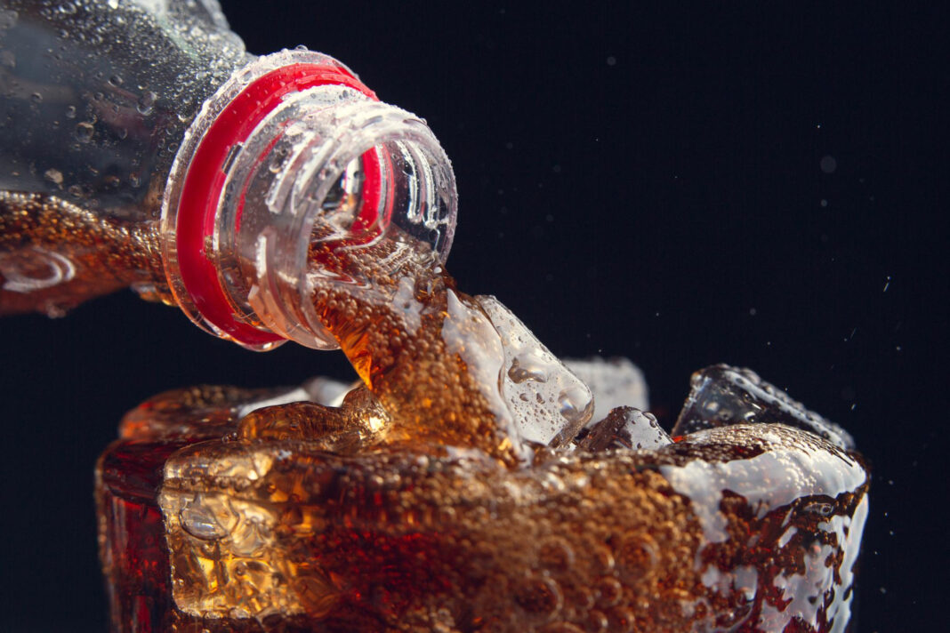 serving-a-cola-from-a-bottle-to-a-glass-full-of-ice